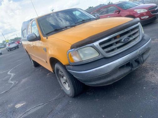 Yellow 2002 Ford F-150 XLT SuperCab