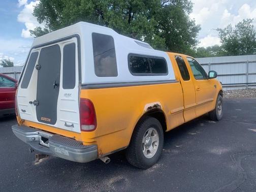 Yellow 2002 Ford F-150 XLT SuperCab
