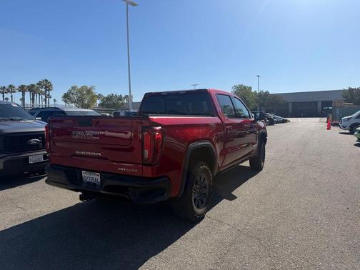 Volcanic Red Tintcoat 2024 GMC Sierra 1500 AT4X