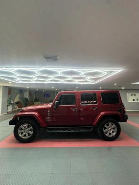 Red 2012 Jeep Wrangler Unlimited Sahara