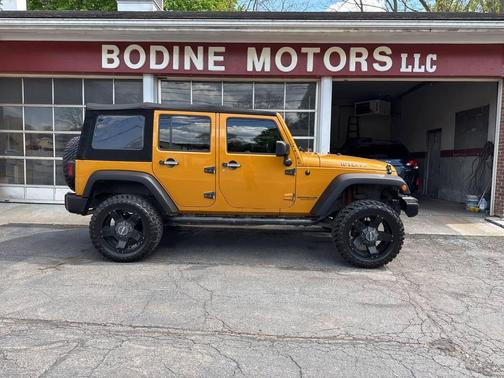 Orange 2014 Jeep Wrangler Unlimited Willys Wheeler Edition 4x4 4dr SUV