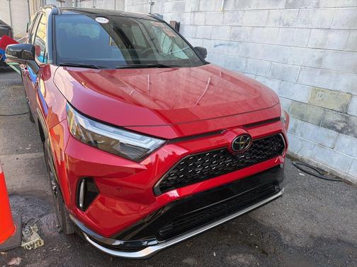 Supersonic Red/Midnight Black Metallic 2025 Toyota RAV4 Hybrid SE