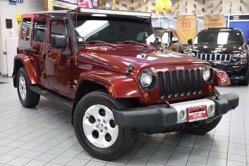 Red 2009 Jeep Wrangler Unlimited Sahara