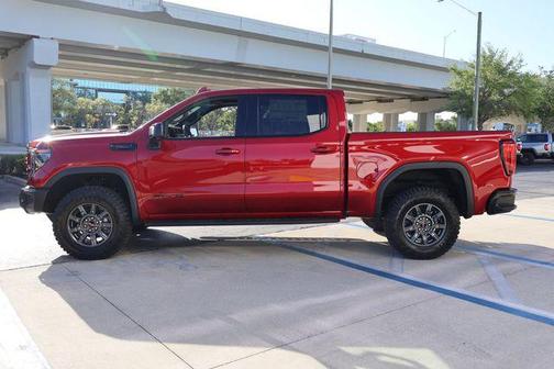 Volcanic Red Tintcoat 2026 GMC Sierra 1500 AT4X