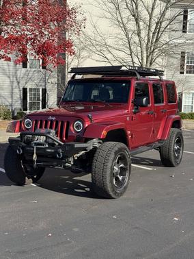 Red 2013 Jeep Wrangler Unlimited Sahara