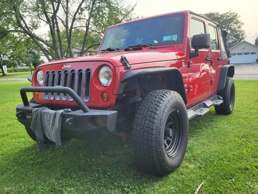 Red 2010 Jeep Wrangler Unlimited Sport