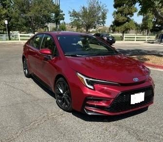 Red 2025 Toyota Corolla Hybrid LE