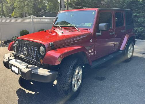 Red 2013 Jeep Wrangler Unlimited Sahara