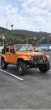 Orange 2013 Jeep Wrangler Unlimited Sahara