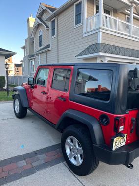 Red 2014 Jeep Wrangler Unlimited Sport