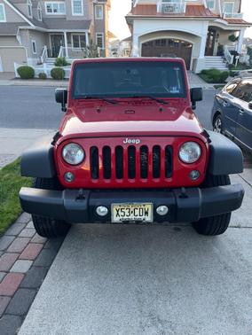 Red 2014 Jeep Wrangler Unlimited Sport