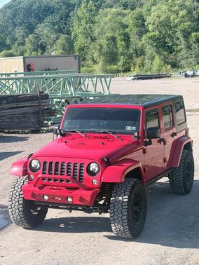 Red 2016 Jeep Wrangler Unlimited Sahara