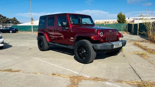 Red 2009 Jeep Wrangler Unlimited Sahara