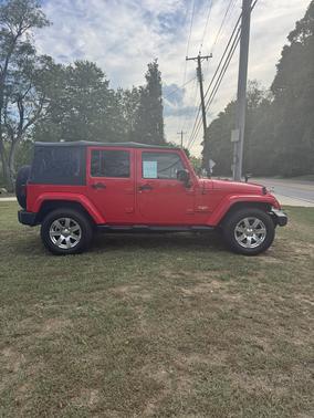 Red 2015 Jeep Wrangler Unlimited Sahara