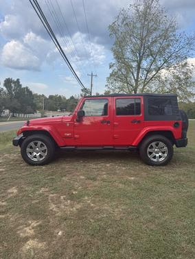 Red 2015 Jeep Wrangler Unlimited Sahara