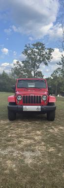 Red 2015 Jeep Wrangler Unlimited Sahara