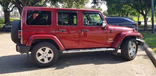 Red 2011 Jeep Wrangler Unlimited Sahara