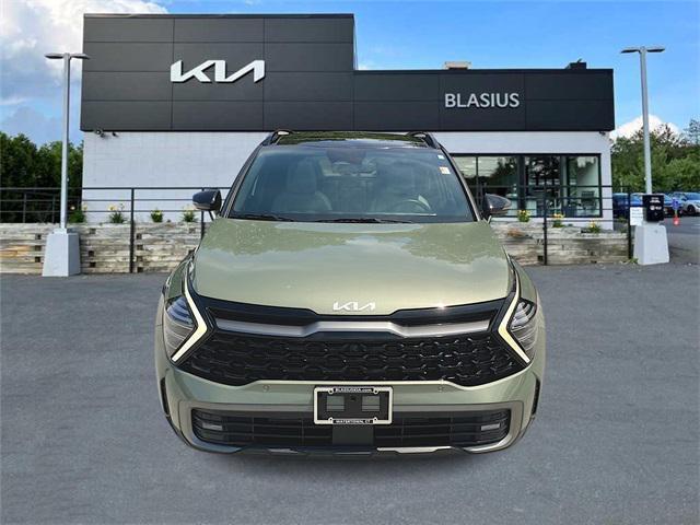 Photo of 2023 Jungle Green/Ebony Black Roof Kia Sportage