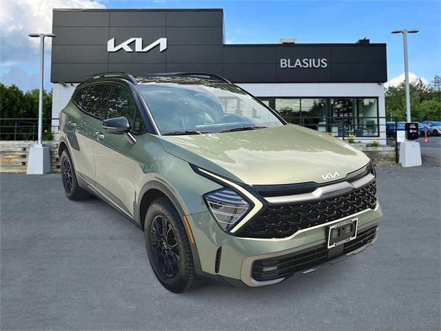 Photo of 2023 Jungle Green/Ebony Black Roof Kia Sportage
