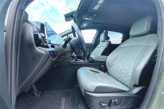 Photo of 2023 Jungle Green/Ebony Black Roof Kia Sportage