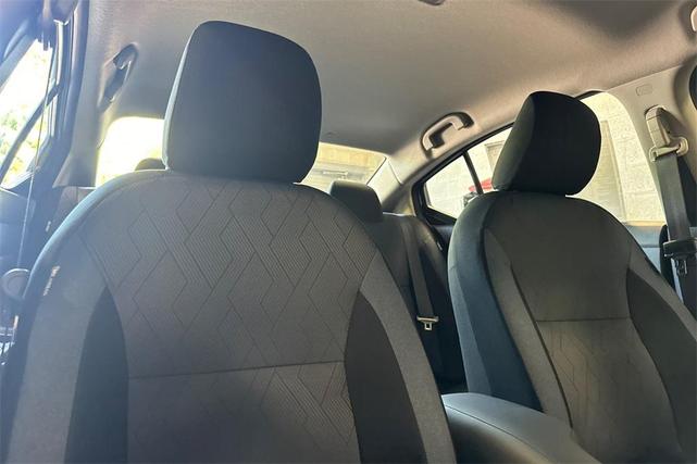 Photo of 2025 Aspen White Tricoat Nissan Versa