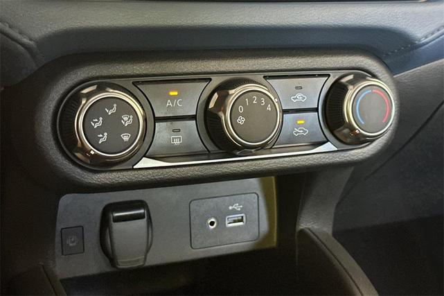Photo of 2025 Aspen White Tricoat Nissan Versa