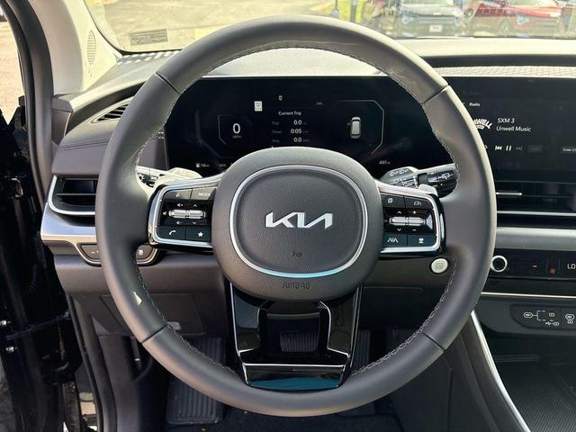 Photo of 2025 Aurora Blue Kia Carnival Hybrid