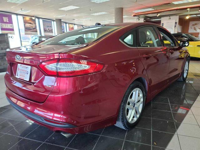 Photo of 2014 Ruby Red Metallic Tinted Clearcoat Ford Fusion