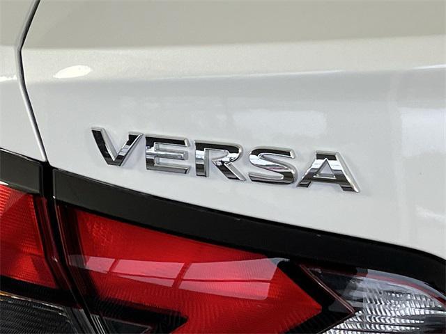 Photo of 2025 Aspen White Tricoat Nissan Versa