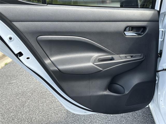 Photo of 2025 Aspen White Tricoat Nissan Versa