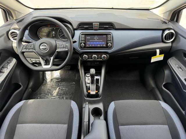 Photo of 2025 Aspen White Tricoat Nissan Versa
