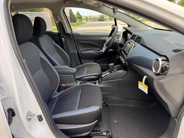 Photo of 2025 Aspen White Tricoat Nissan Versa