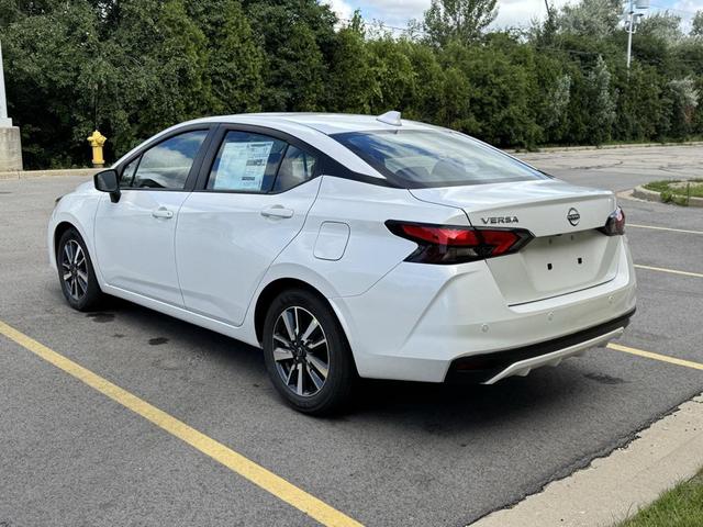 Photo of 2025 Aspen White Tricoat Nissan Versa
