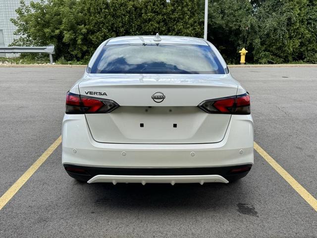 Photo of 2025 Aspen White Tricoat Nissan Versa