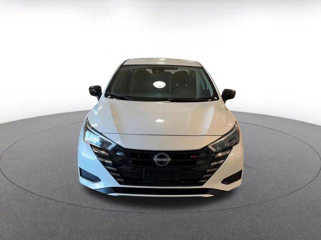 Photo of 2024 Aspen White Tricoat Nissan Versa