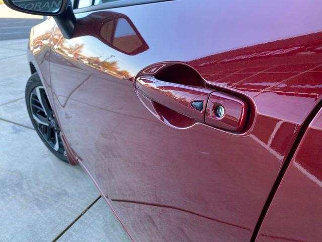 Photo of 2025 Scarlet Ember Tintcoat Nissan Versa
