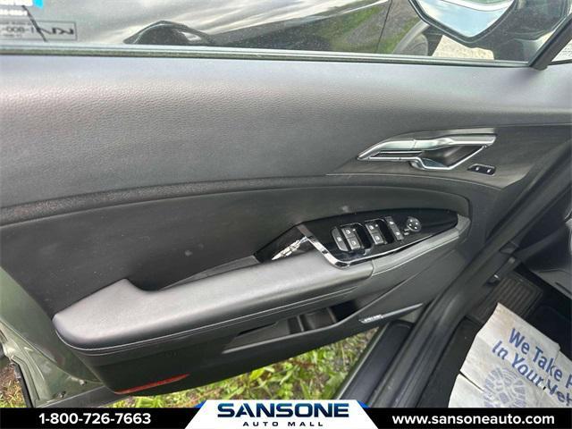 Photo of 2023 Jungle Green/Ebony Black Roof Kia Sportage