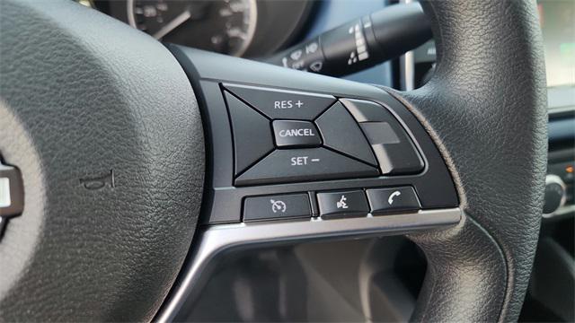 Photo of 2025 Aspen White Tricoat Nissan Versa