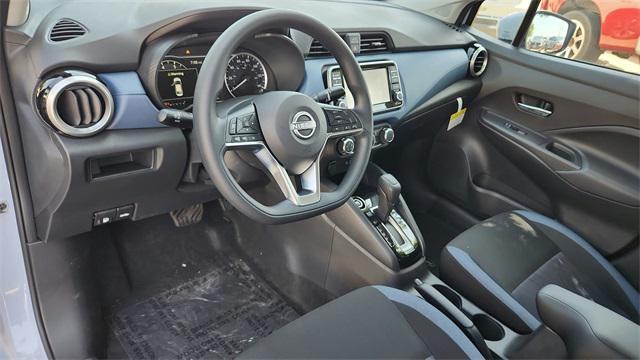Photo of 2025 Aspen White Tricoat Nissan Versa