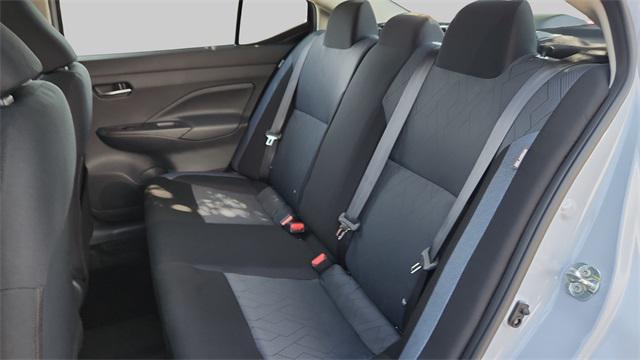 Photo of 2025 Aspen White Tricoat Nissan Versa