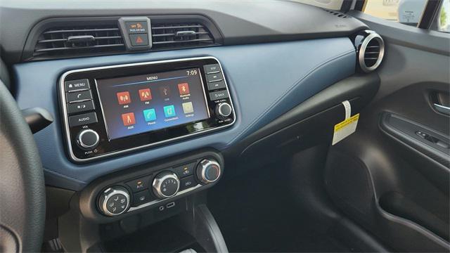 Photo of 2025 Aspen White Tricoat Nissan Versa