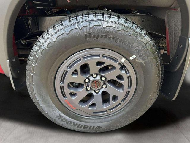 Photo of 2025 Cardinal Red Metallic Tricoat Nissan Frontier