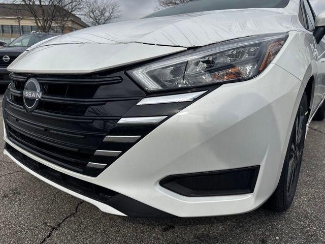 Photo of 2025 Aspen White Tricoat Nissan Versa