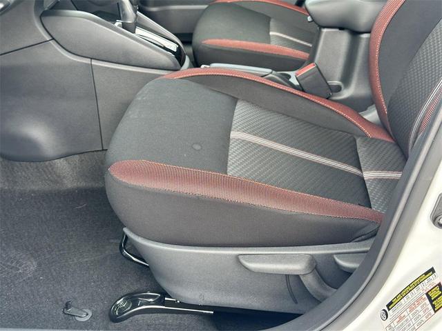 Photo of 2025 Aspen White Tricoat Nissan Versa
