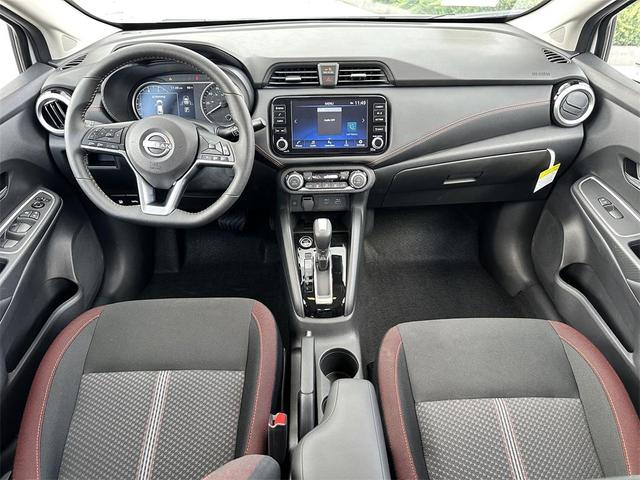 Photo of 2025 Aspen White Tricoat Nissan Versa