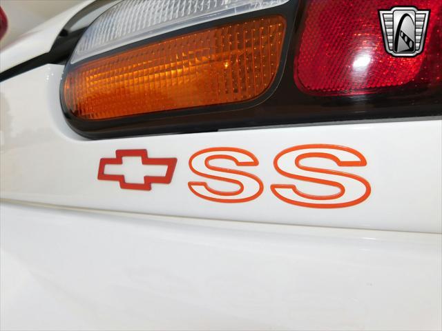 Photo of 1997 White with orange racing stripes Chevrolet Camaro