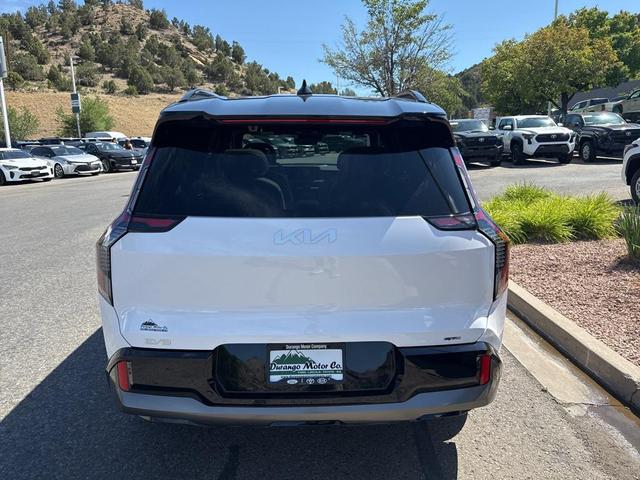 Photo of 2026 Glacier White Pearl/Ebony Black Roof Kia EV9