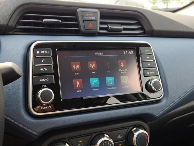 Photo of 2025 Aspen White Tricoat Nissan Versa