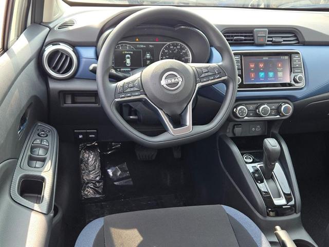 Photo of 2025 Aspen White Tricoat Nissan Versa