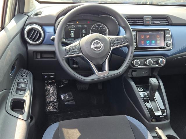 Photo of 2025 Aspen White Tricoat Nissan Versa